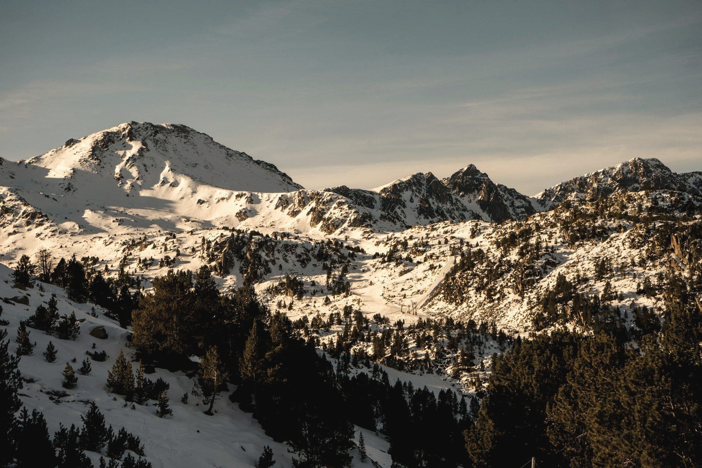 Snow-covered mountain under a pale sky